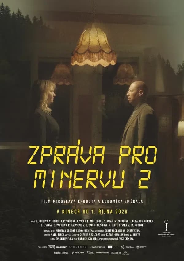 A man and woman stand facing each other in a dimly lit room under hanging lamps.