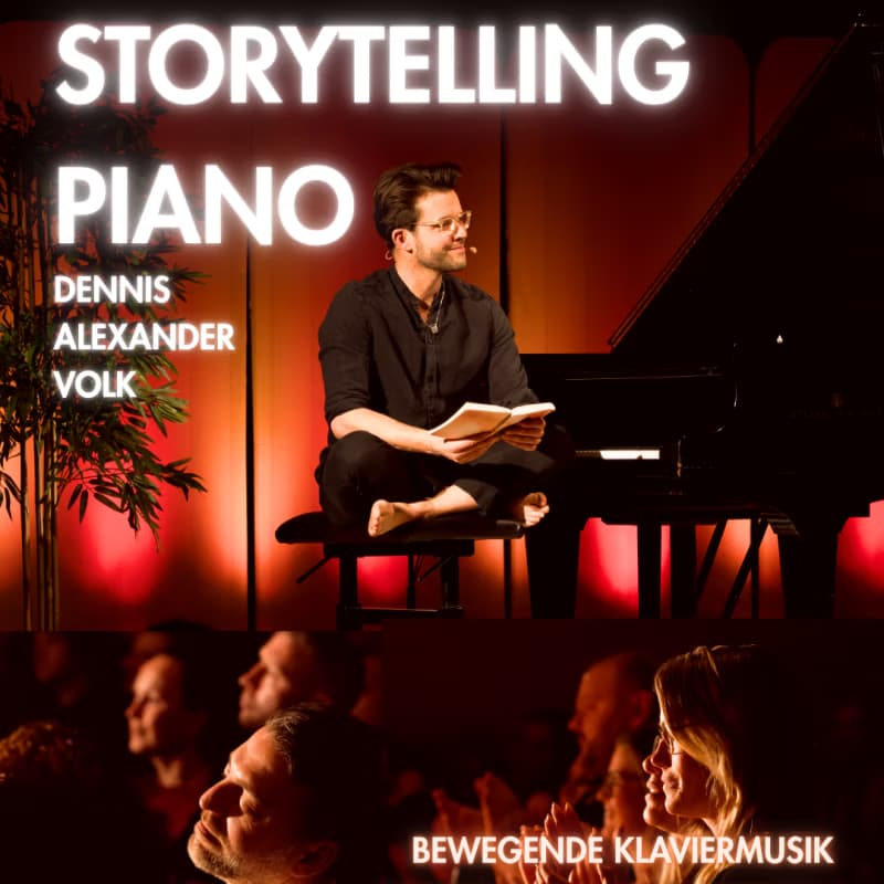 A man sits barefoot on a piano bench reading a book beside a grand piano on stage.
