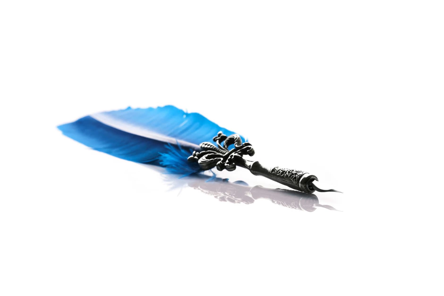 A vibrant blue quill pen with an ornate metal nib rests on a white background.