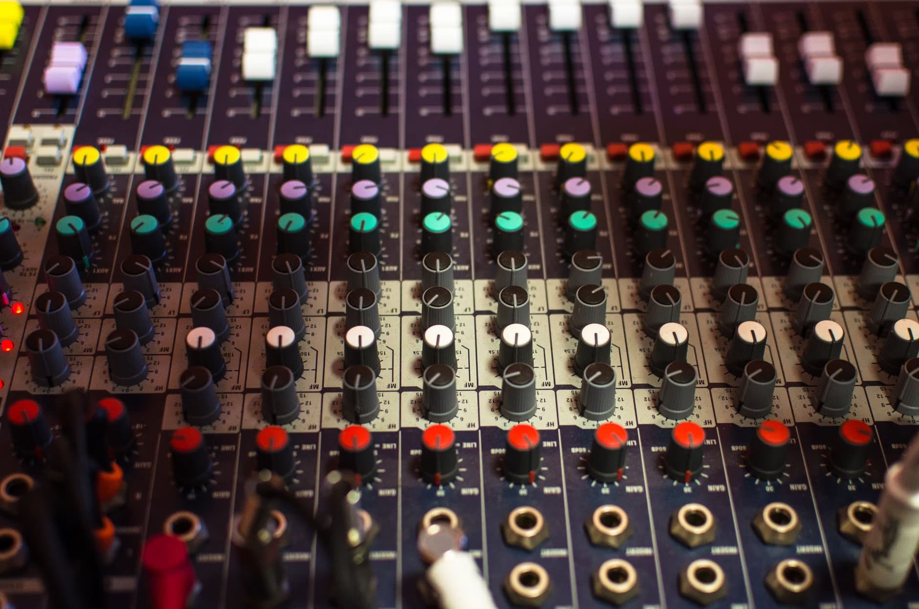 A close-up view showing the control panel of a large professional audio mixing console.