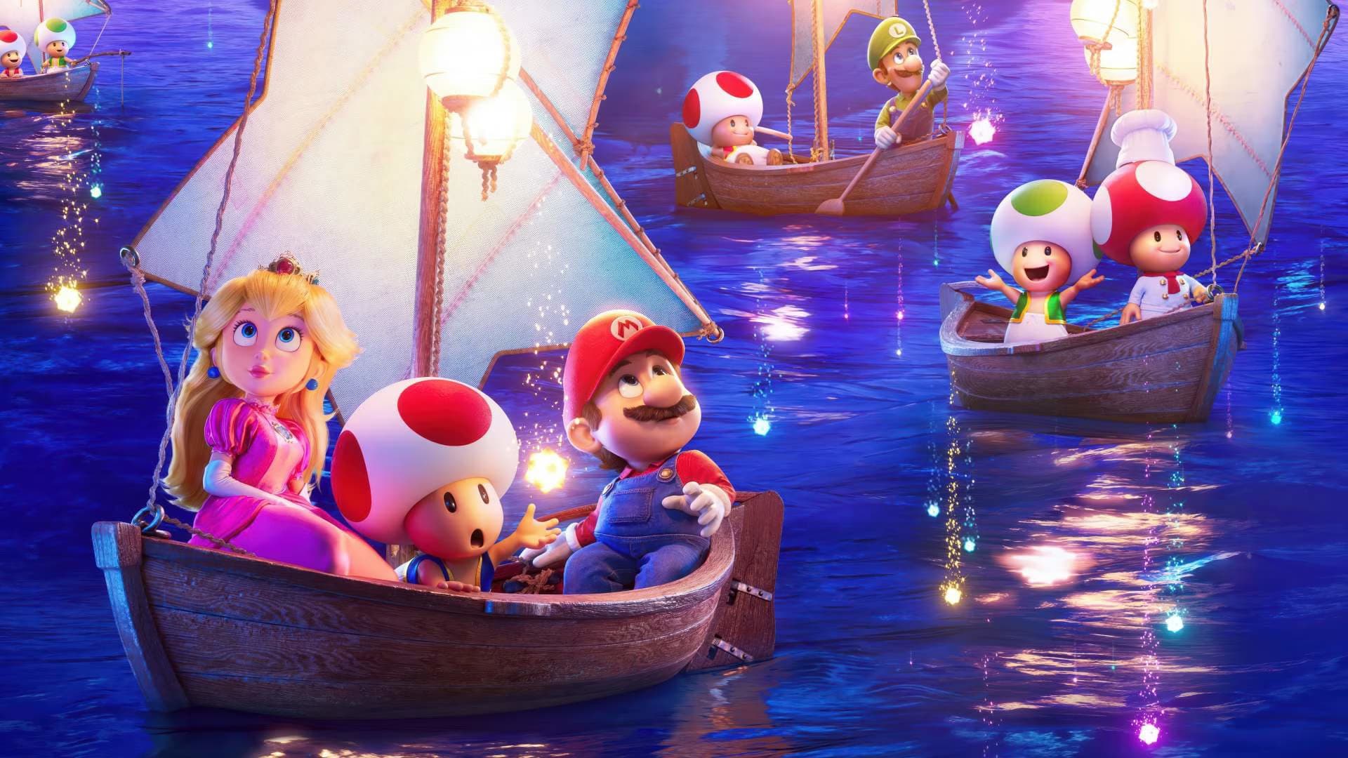Die Mario-Charaktere Peach, Toad und Mario fahren nachts in kleinen Holzsegelbooten über leuchtendes Wasser.