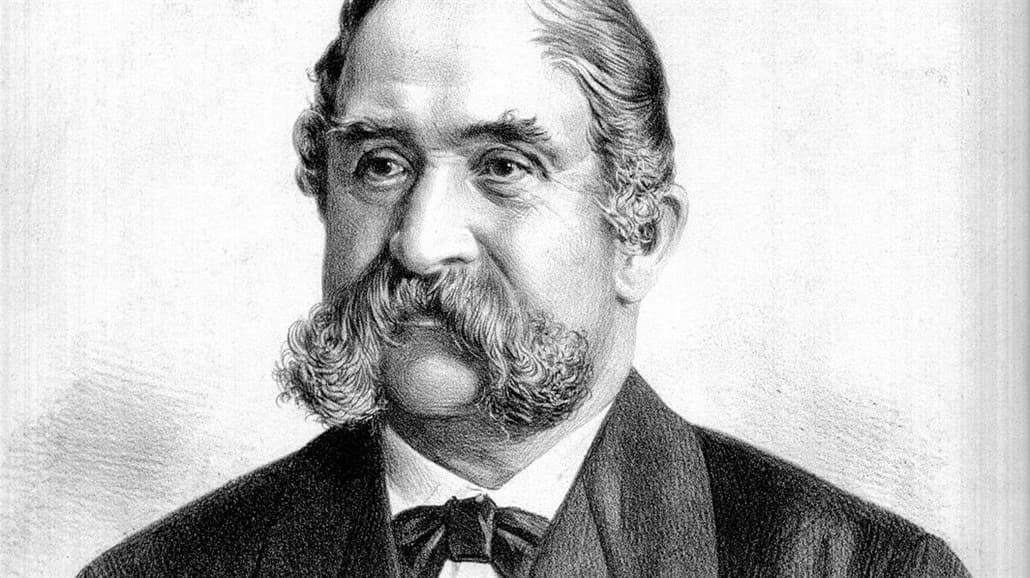 Historical black and white portrait of a distinguished older man with a prominent mustache.