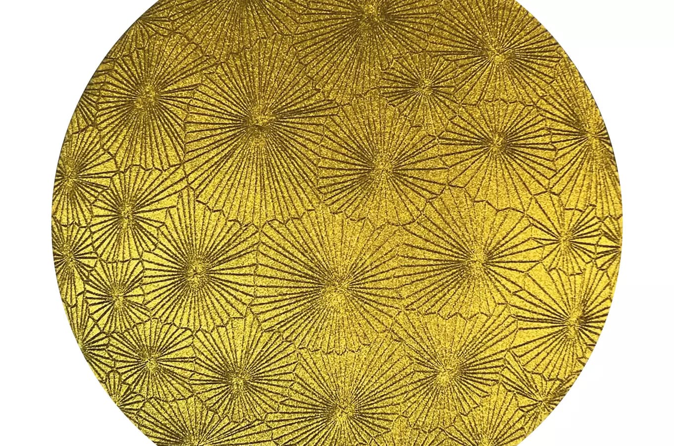 A circular gold object displays a repetitive, intricate radiating starburst pattern.
