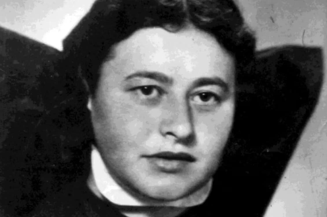 Black and white close-up portrait of a woman with dark hair.