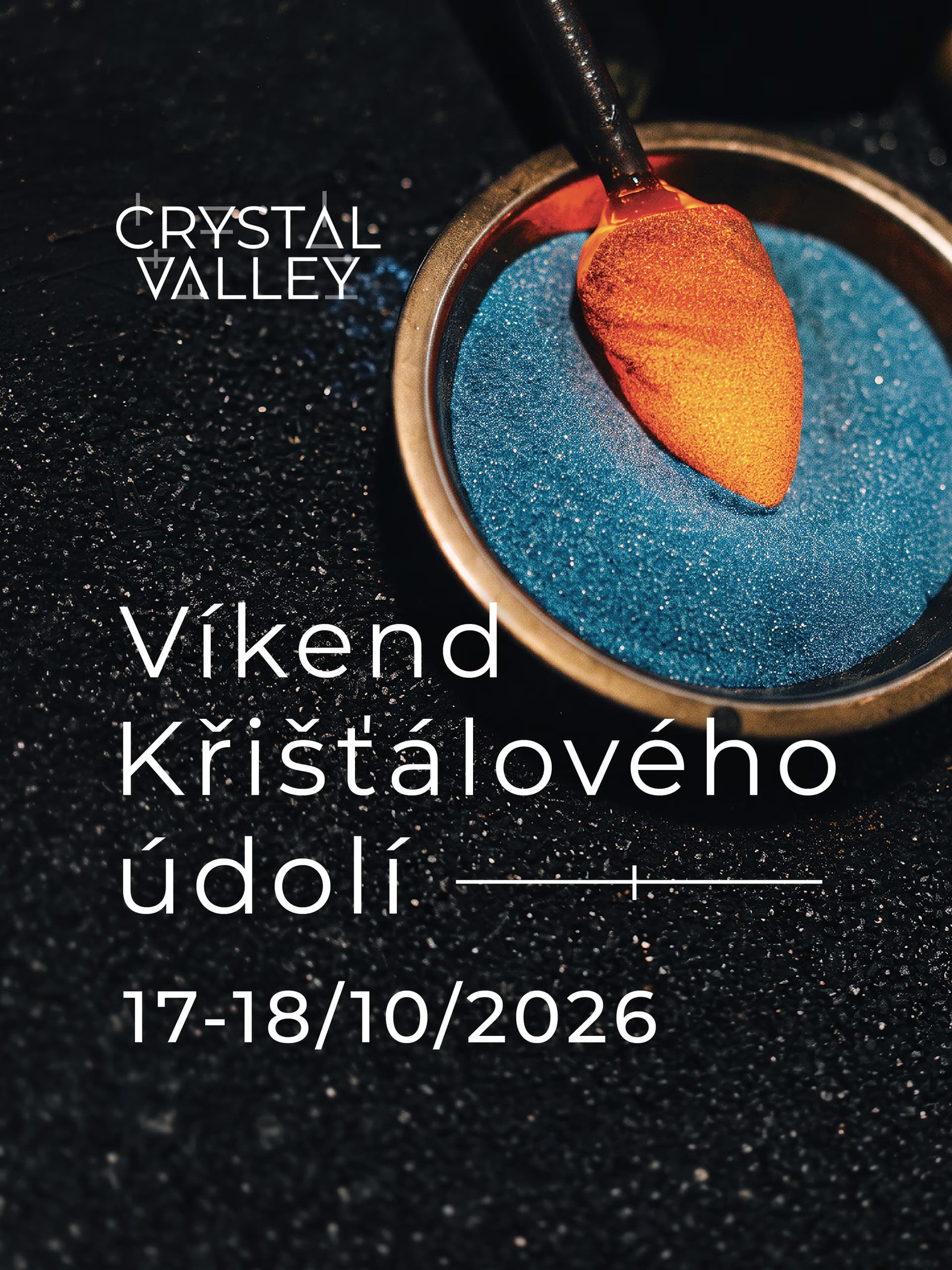 A glassblower's tool dips into a bowl of blue glass frit for the Crystal Valley Weekend event.